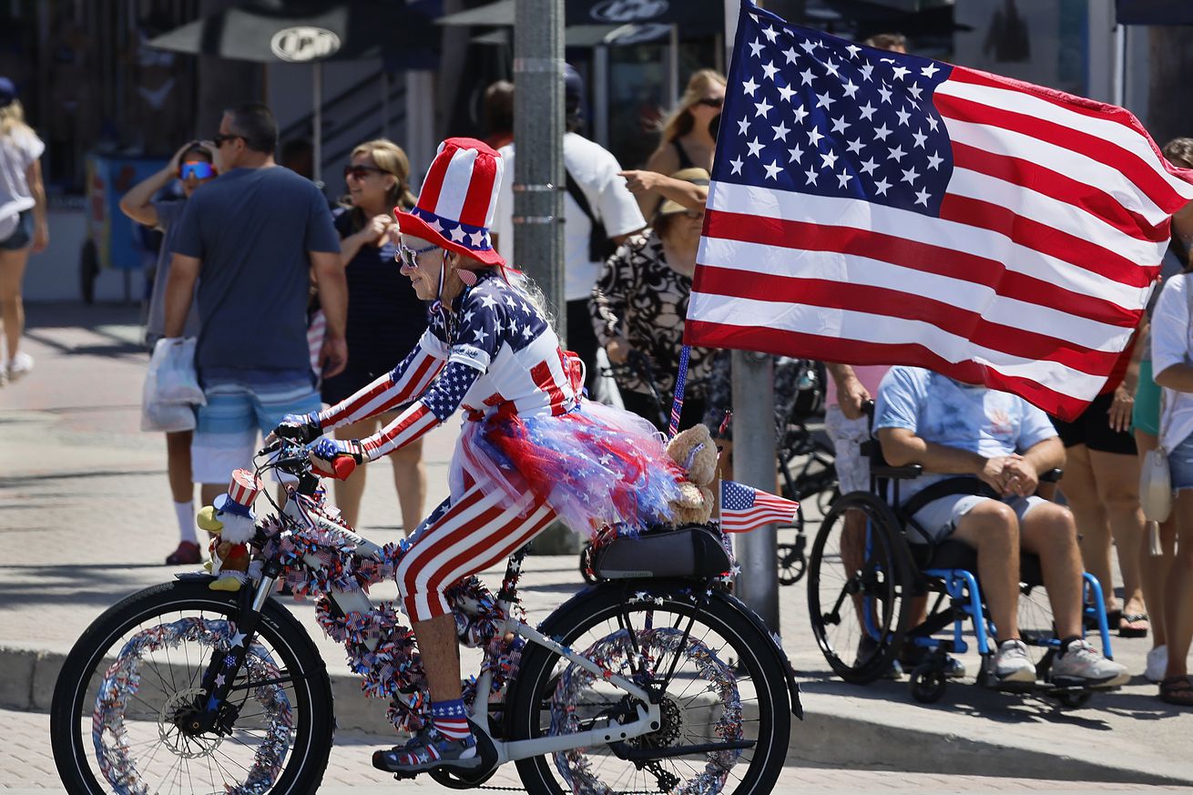 Hundreds of patriotic bicyclists cruise down Main Street during the 5th Annual Huntington Beach Locals 4th of July Bicycle Cruise, in advance of the annual Independence Day Parade and Fireworks celebration in Huntington Beach.