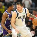 Sacramento Kings point guard De'Aaron Fox defends Dallas Mavericks point guard Luka Doncic